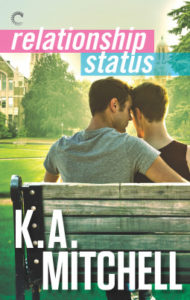 Two young guys, from the back, one with his arm around the other, sitting on a park bench