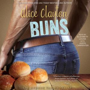 picture of the lower back of a muscular, trim, shirtless man in blue jeans with a brown belt - the top of his butt is featured in those jeans. In the foreground are some bread rolls on a wooden bench.