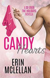 Very edge of a the body and upper legs of a hot young white guy wearing only lacy boy shorts and holding a pair of pink boxer briefs from one upraised finger