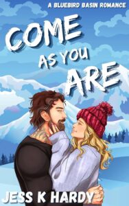 Illustrated cover with a snowy mountain background in blues and whites. In the foreground a good looking white couple embrace. He has dark shaggy hair and a beard and tattoos and is wearing a dark sweater, she has a purple coat and a pink bobble hat on. They are smiling at each other.